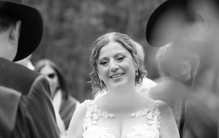Bride holding back tears during vows at outdoor western-style Sherwood Park wedding
