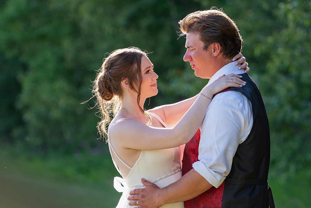 Bride and groom share romantic first dance outdoors at sunset