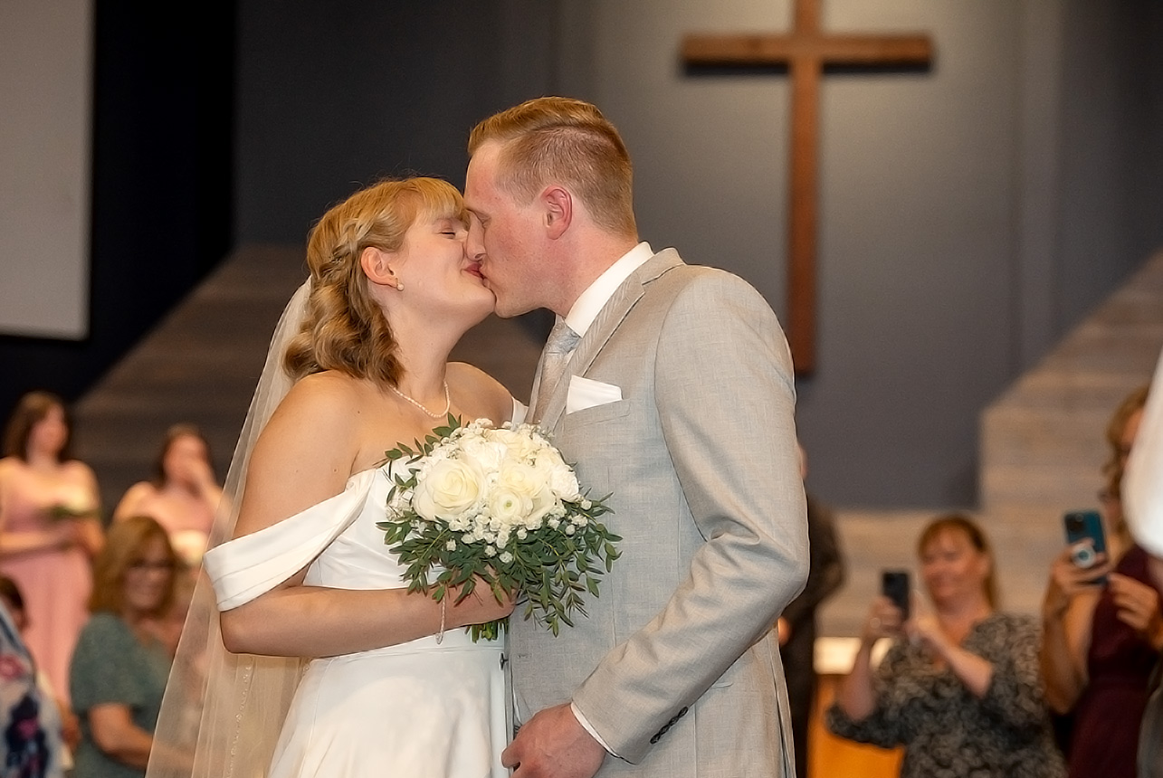 erin-eric-first-kiss-ceremony Bride and groom’s first kiss at the altar