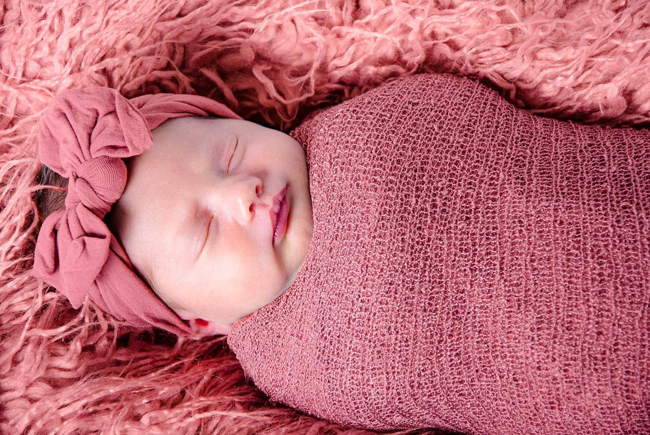 Darling Newborn in Pink Outfit with Flower Headband